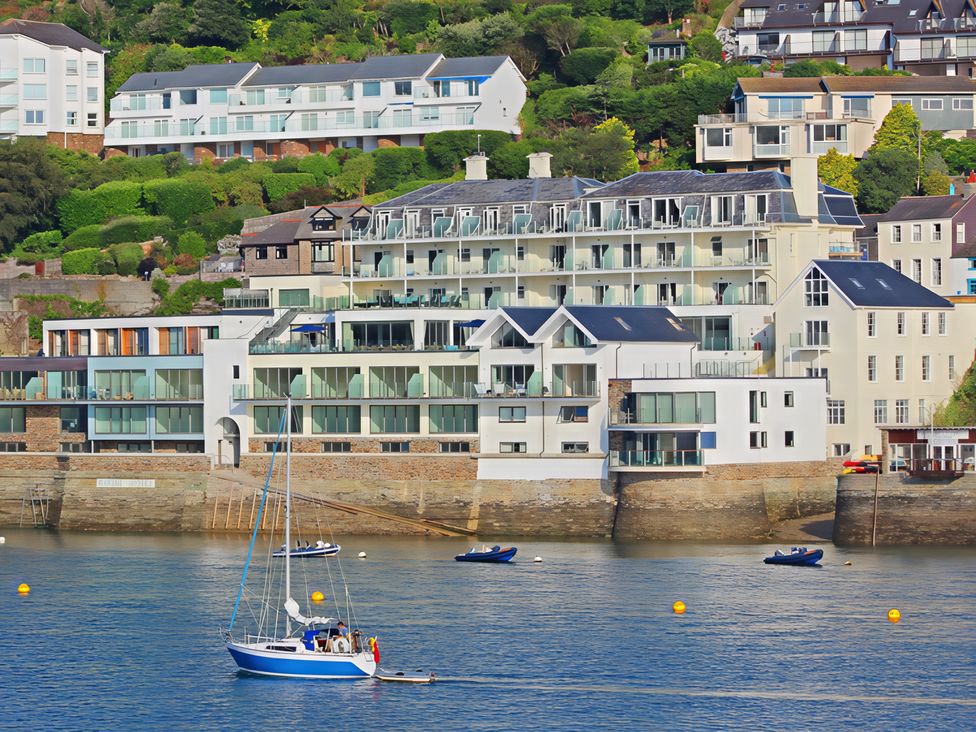 Buildings near water with boats in the bay at Villa 8, Estura Salcombe