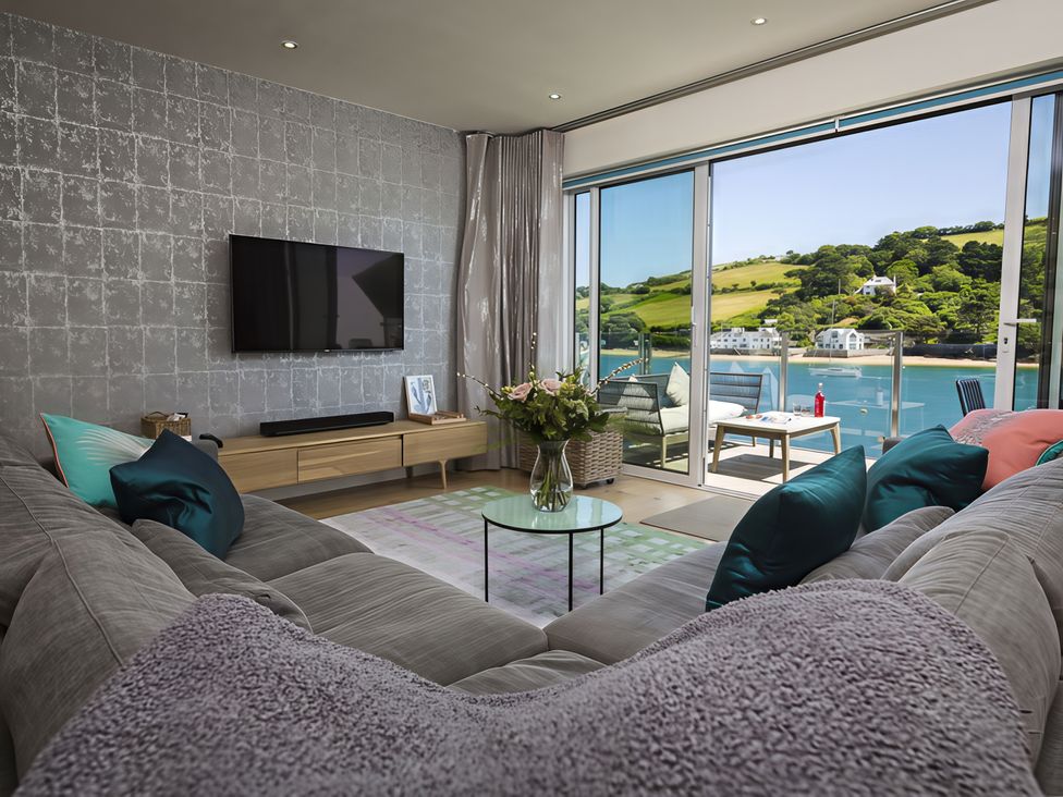 A living room with a sofa and television at Villa 8, Estura Salcombe