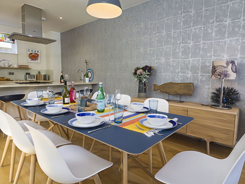 A dining room with tableware and drinks at Villa 8, Estura Salcombe