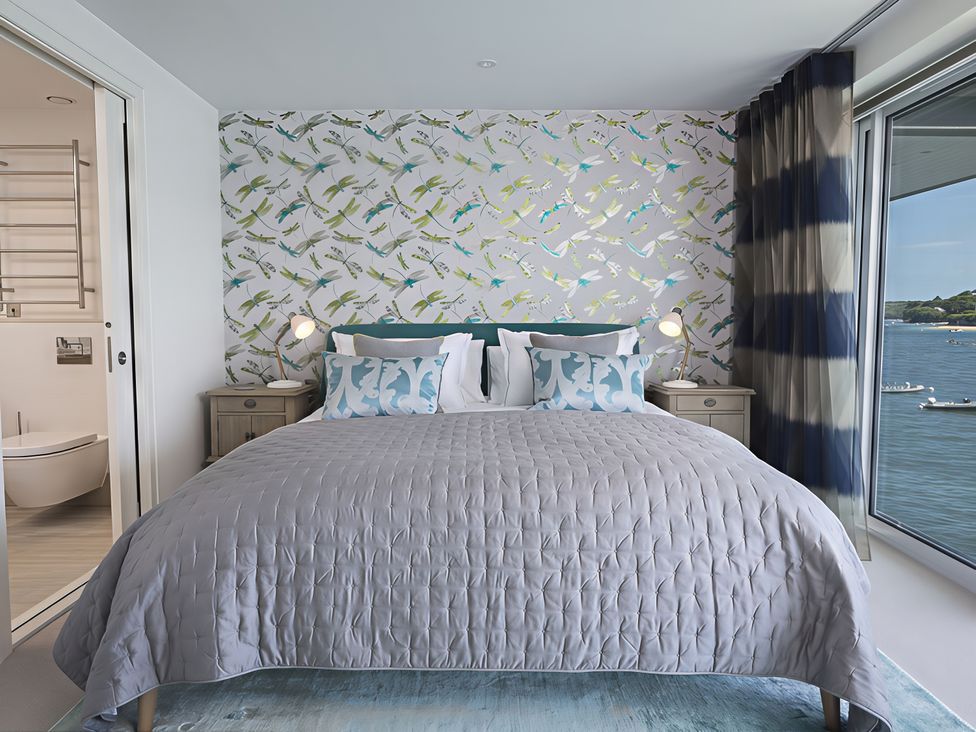 A bedroom with a bed and bedside table at Villa 8, Estura Salcombe