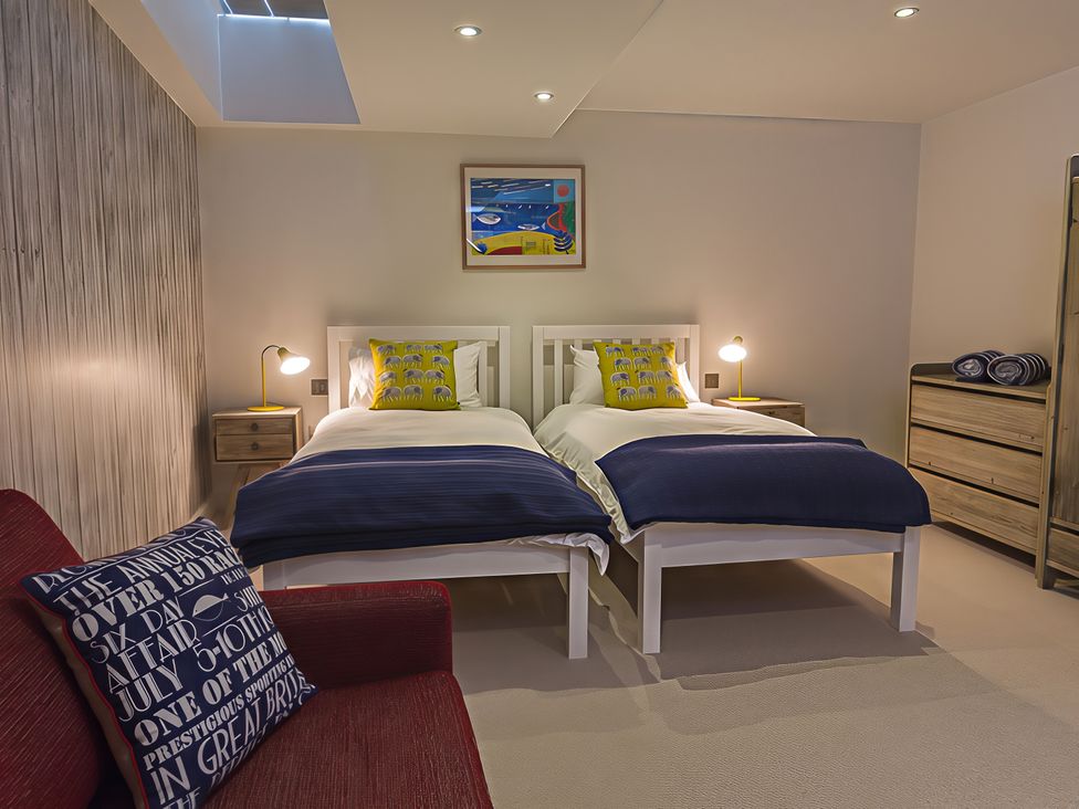 A bedroom with two beds and a chest of drawers at Villa 8, Estura in Salcombe