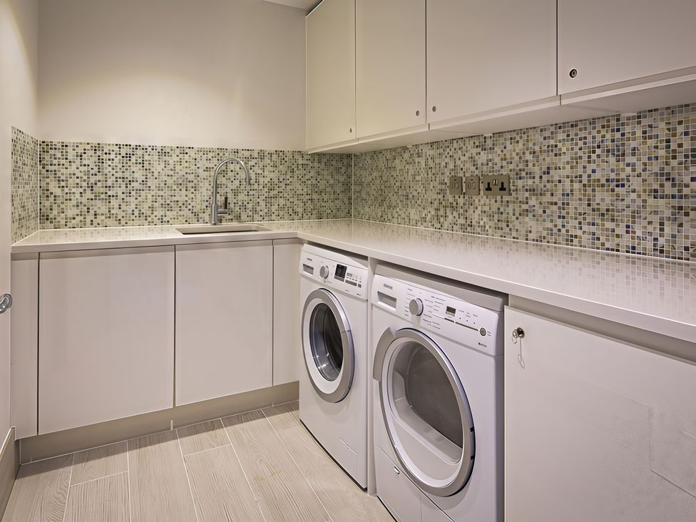 A laundry room with a washing machine and dryer at Villa 8, Estura in Salcombe