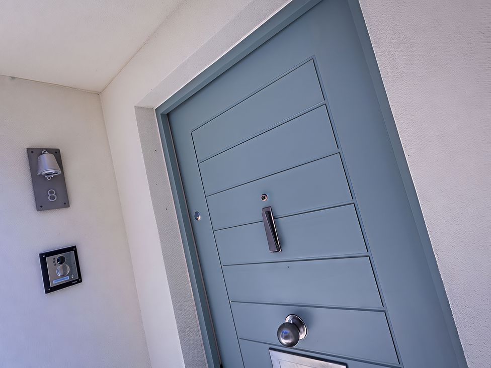 An entrance with a blue door, a doorbell, and an apartment number at Villa 8, Estura in Salcombe