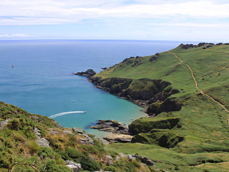 A scenic view of a coastline with hills and water at Villa 8, Estura Salcombe