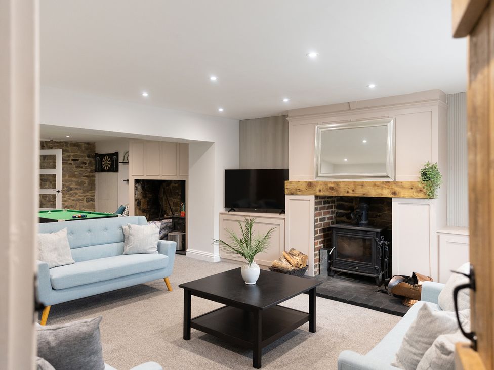 A living room with a coffee table and a television at 6 Front Street