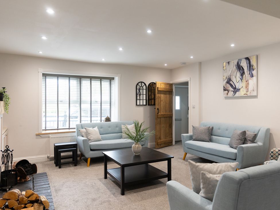 A living room with two sofas and a table at 6 Front Street