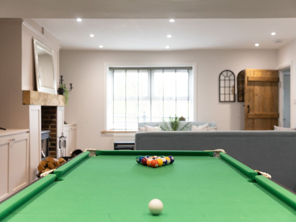A pool table with billiard balls in a game room at 6 Front Street