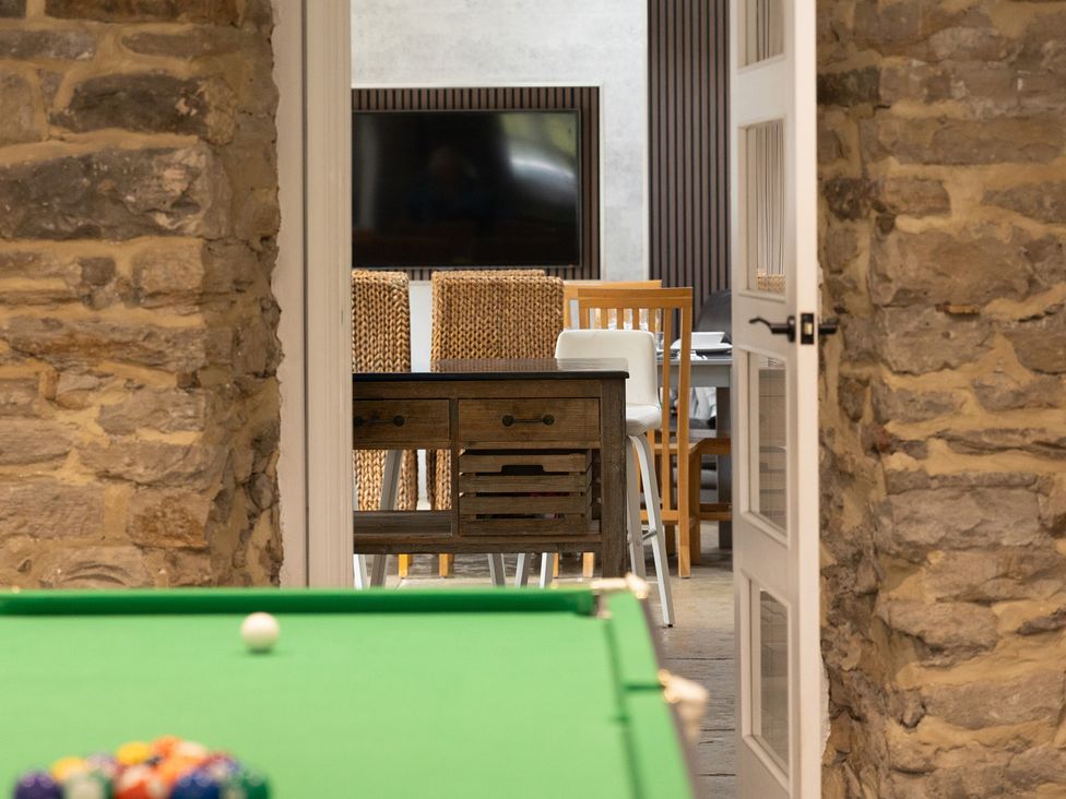 A game room with a pool table and a view of a dining area at 6 Front Street