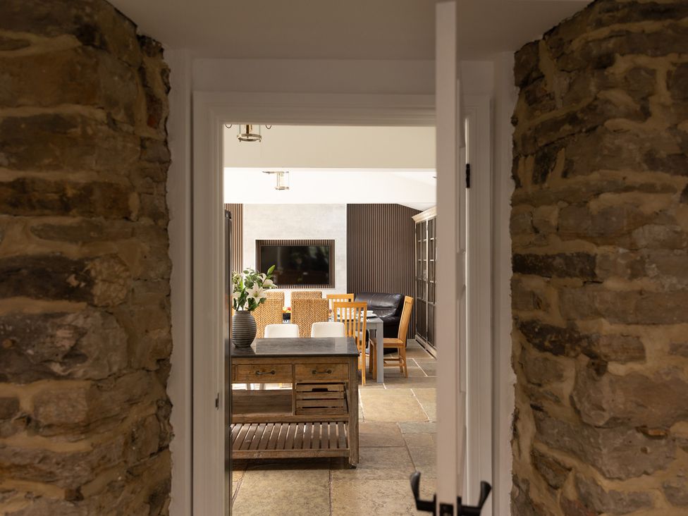 A dining room with a table and chairs viewed from a doorway at 6 Front Street