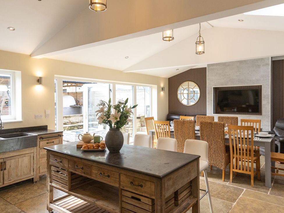 A kitchen with wooden furniture and dining area at 6 Front Street