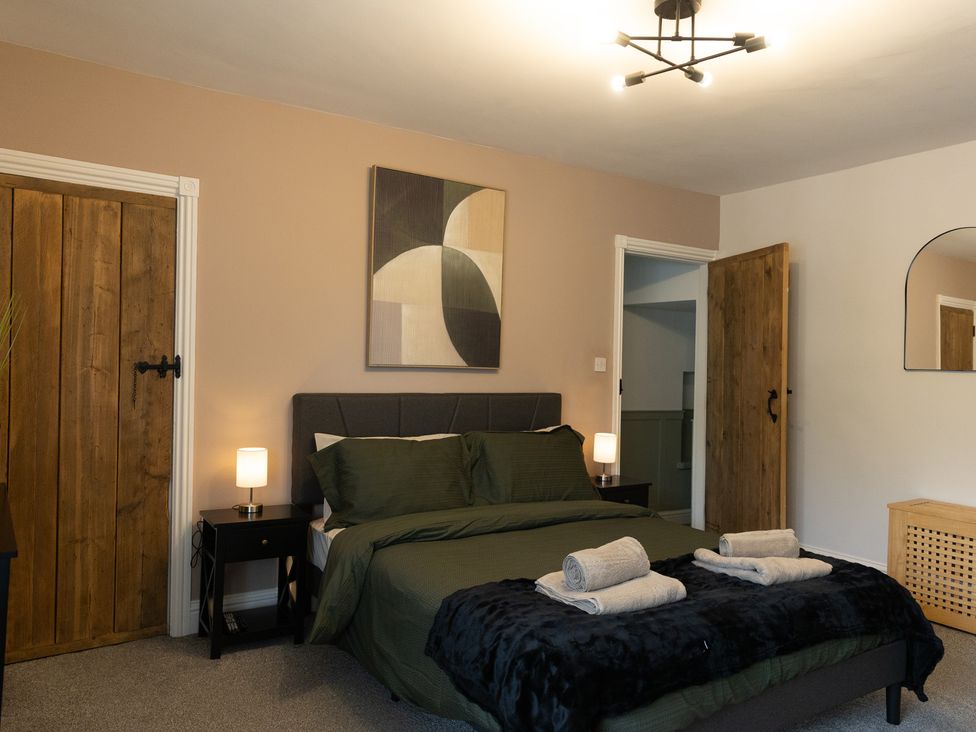 A bedroom with a bed and nightstands at 6 Front Street 