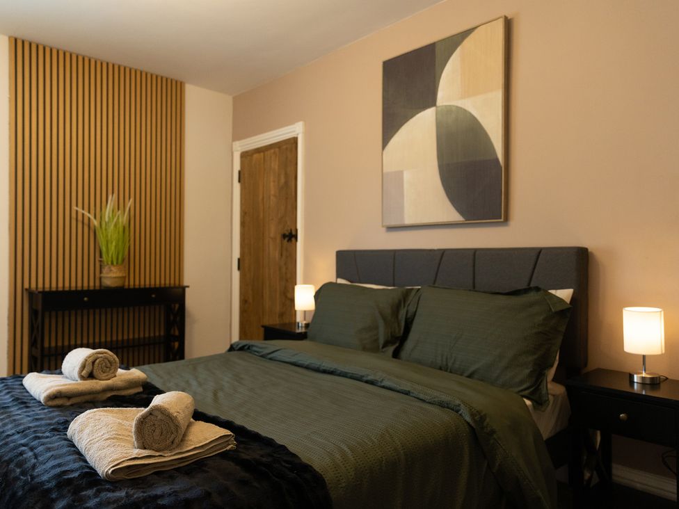 A bedroom with a bed and a plant at 6 Front Street