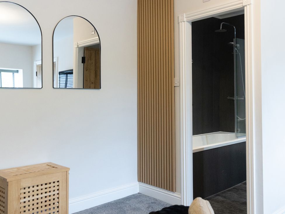 A bathroom with a shower and bathtub at 6 Front Street