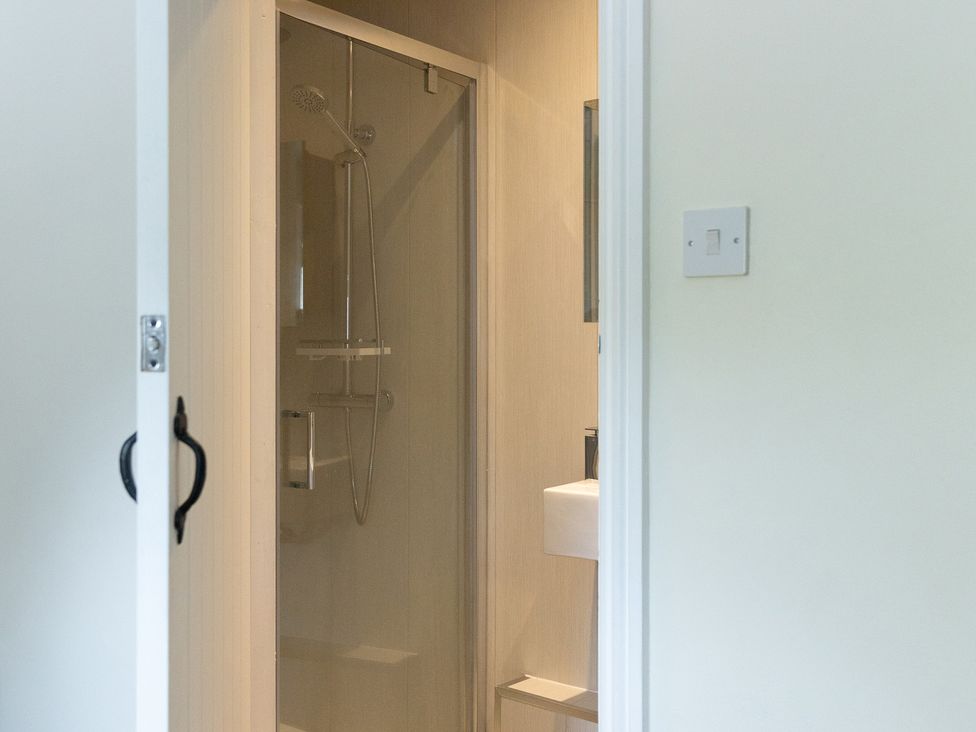 A shower and wash basin in a bathroom at 6 Front Street