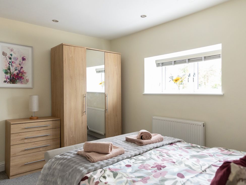 A bedroom with a bed, wardrobe, and dresser at 6 Front Street