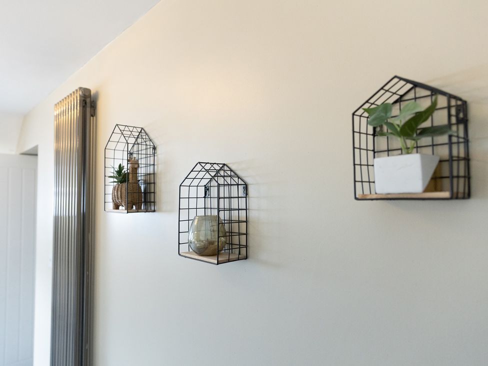 Wall shelves with plants and decorative items at 6 Front Street