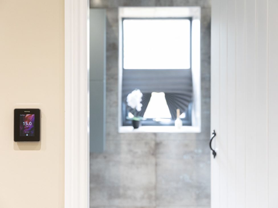 A thermostat and window view in a bathroom at 6 Front Street