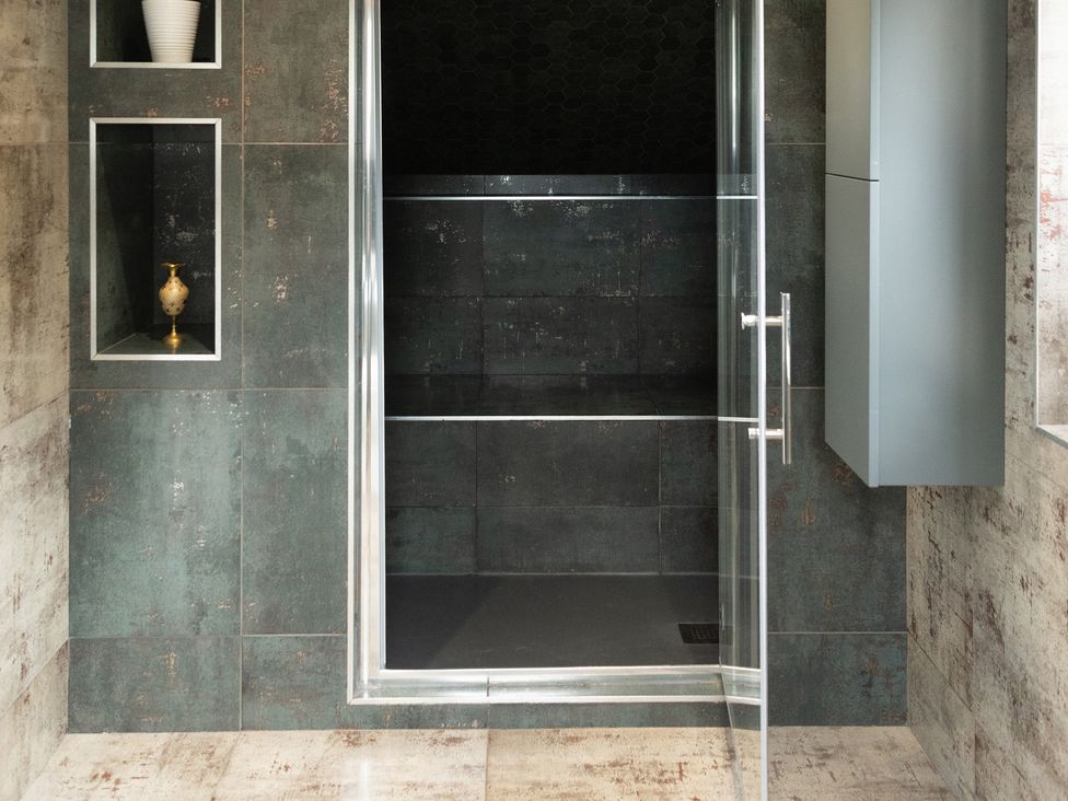A shower with glass doors in a bathroom at 6 Front Street