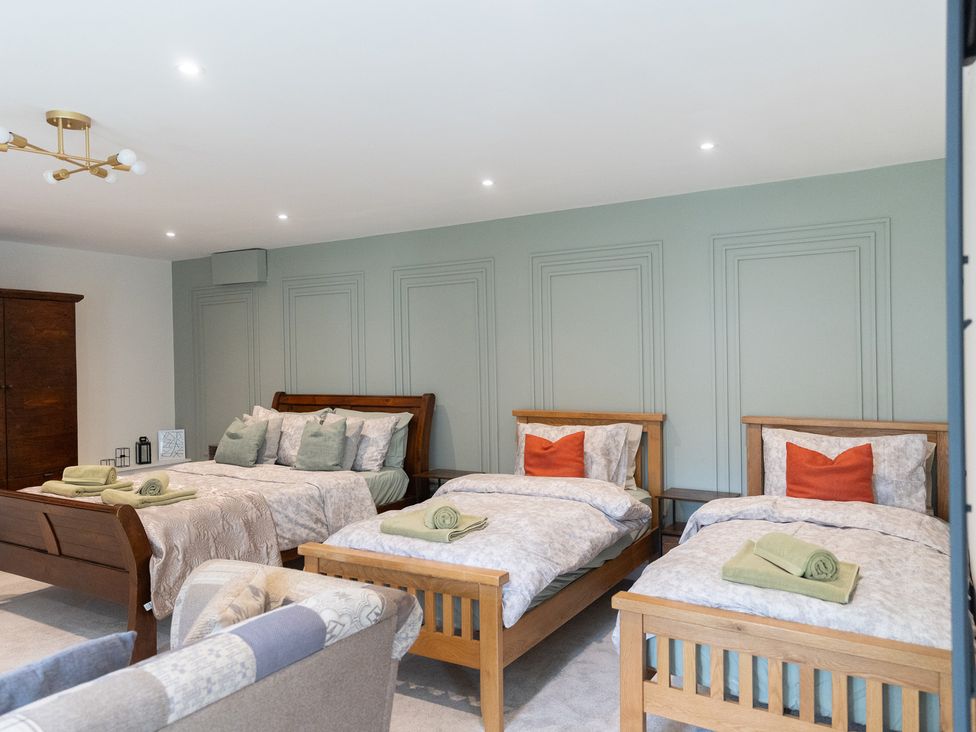 A bedroom with multiple beds and furniture at 6 Front Street