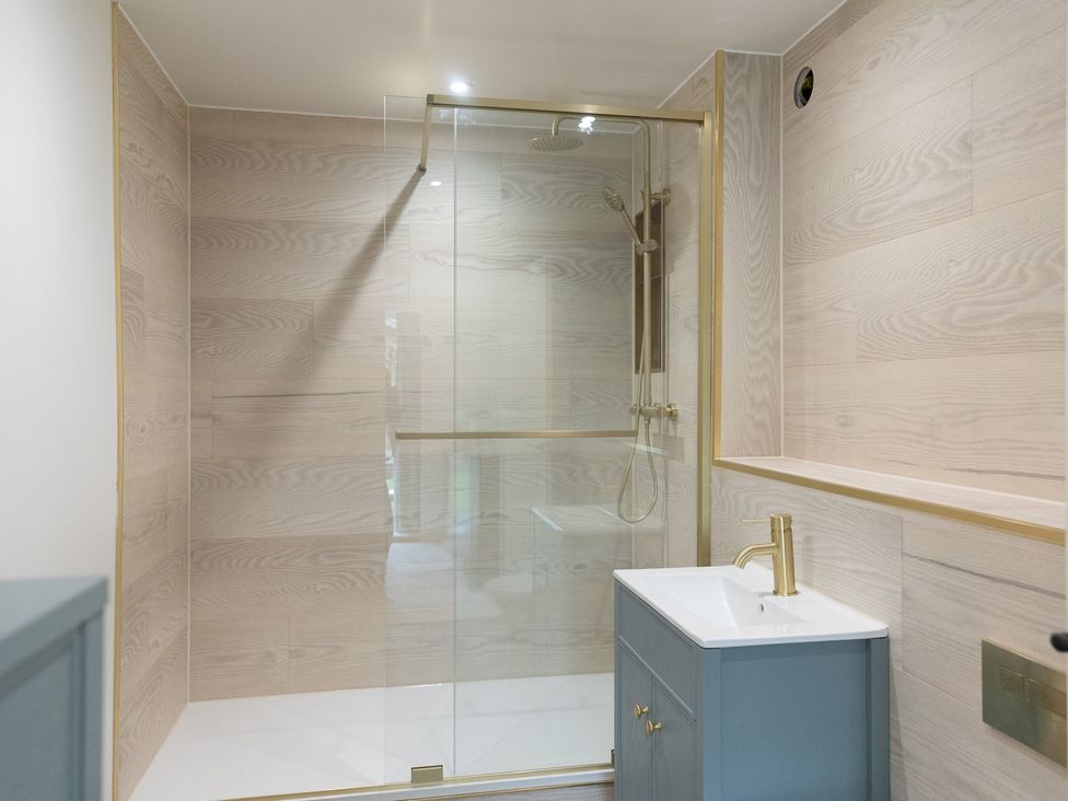 A bathroom with a shower and sink at 6 Front Street 