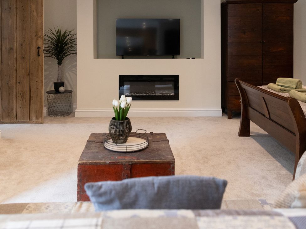 A living room with a television and electric fireplace at 6 Front Street