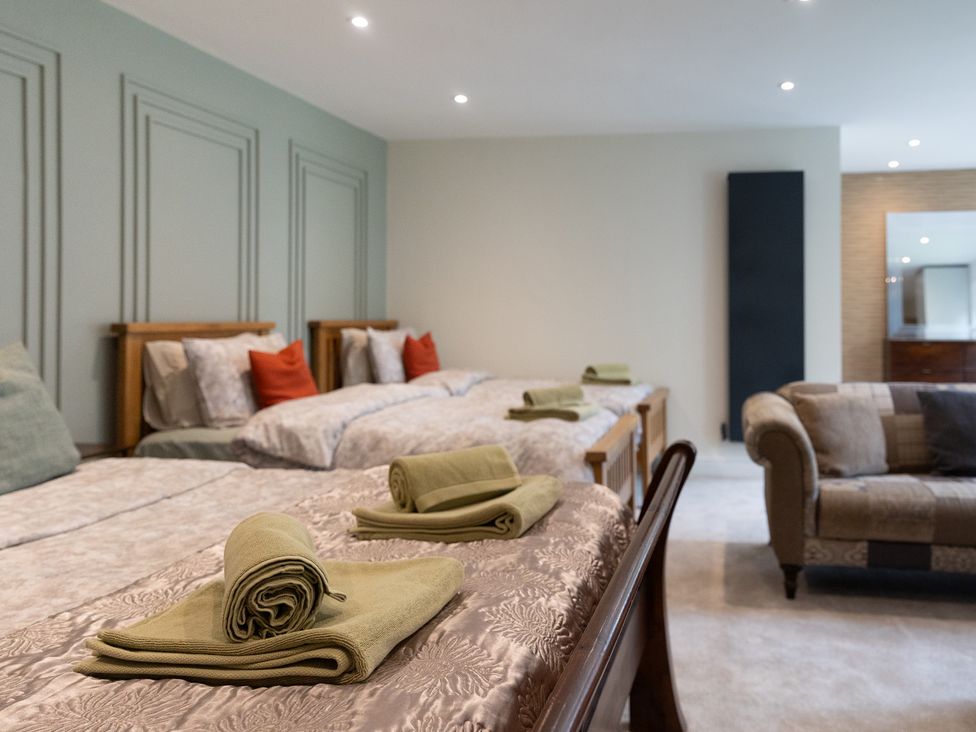 A bedroom with beds and a couch at 6 Front Street