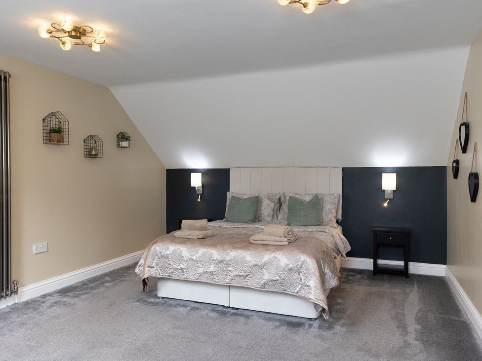 A bedroom with a bed and bedside table at 6 Front Street