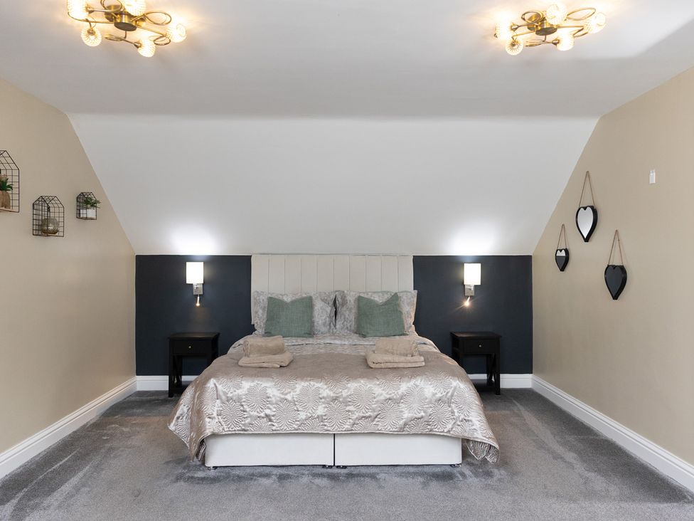 A bedroom with a bed and nightstands at 6 Front Street