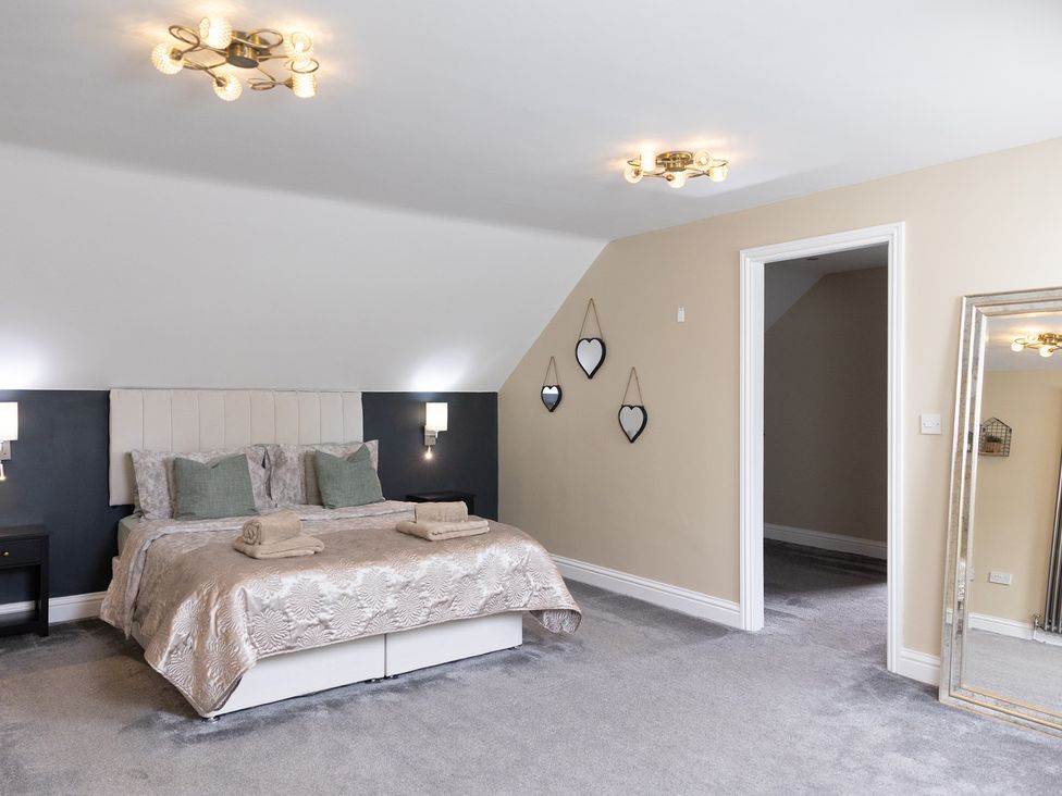 A bedroom with a bed and mirror at 6 Front Street 