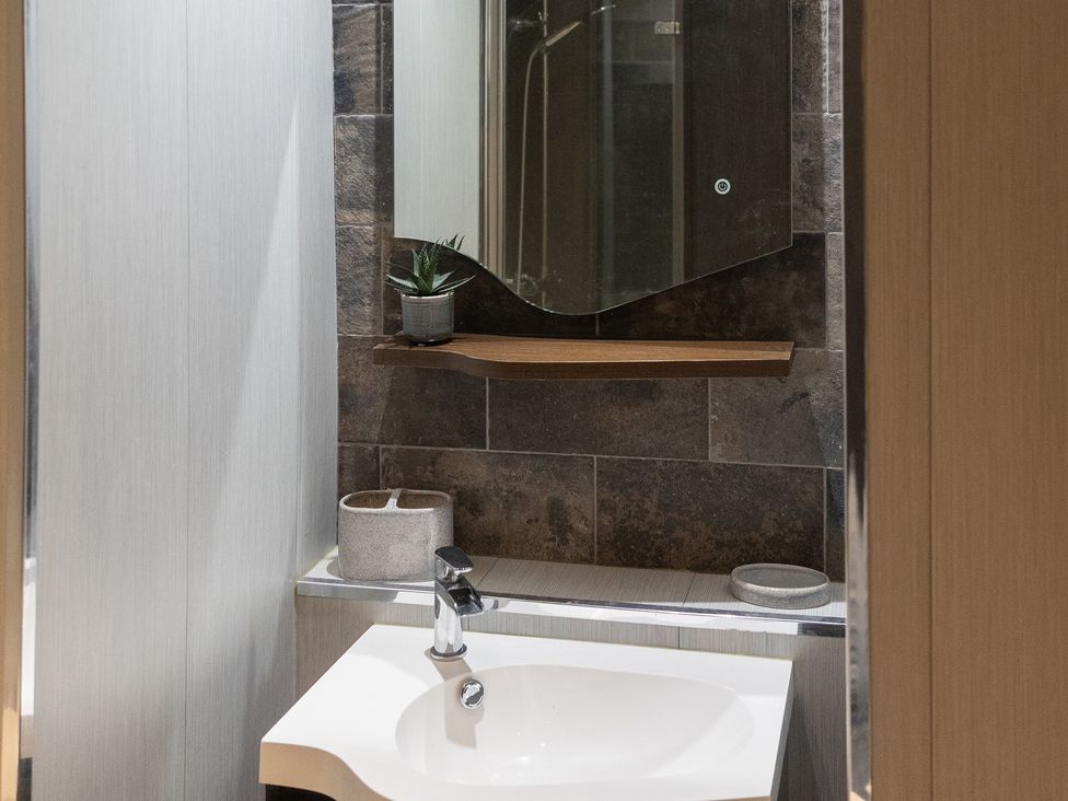 A bathroom with a sink and mirror at 6 Front Street