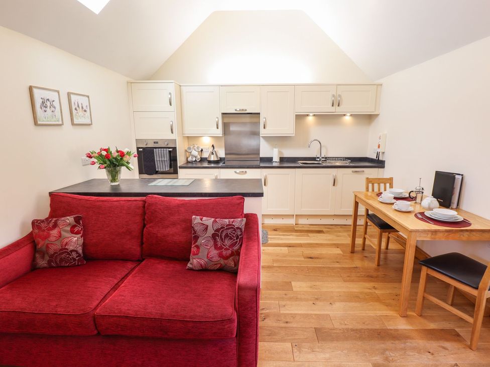 A kitchen with a sofa and dining table at The Stables in Louth