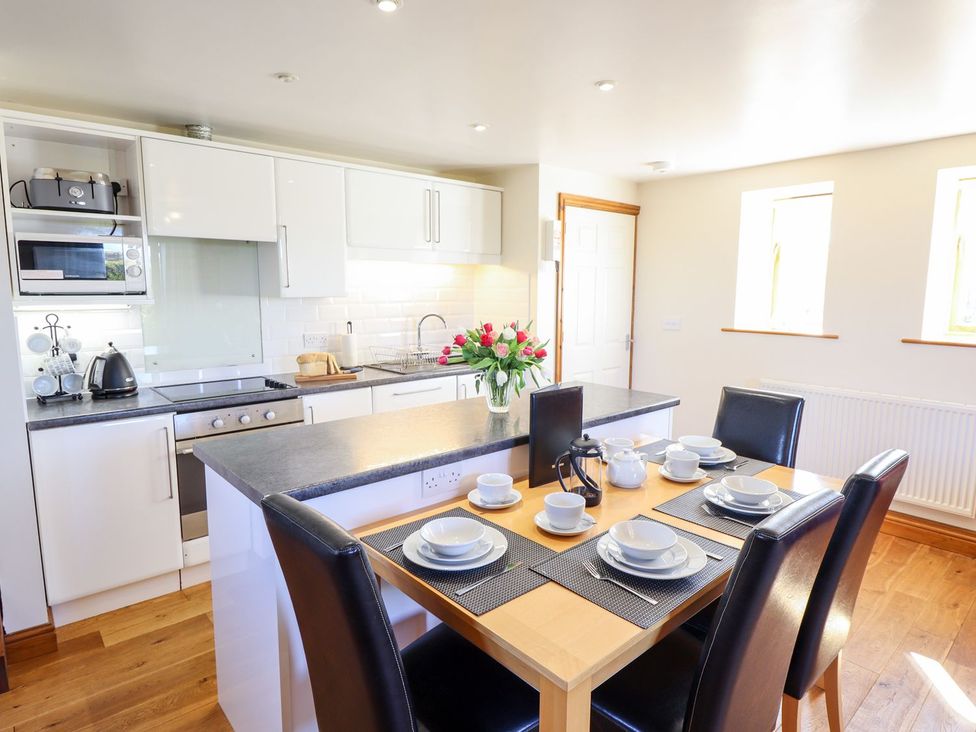 A kitchen with a dining table and chairs at The Mill House in Louth
