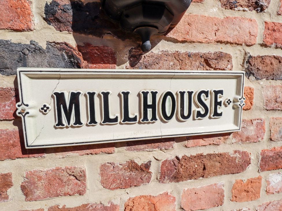 A sign for Millhouse on a brick wall at The Mill House in Louth