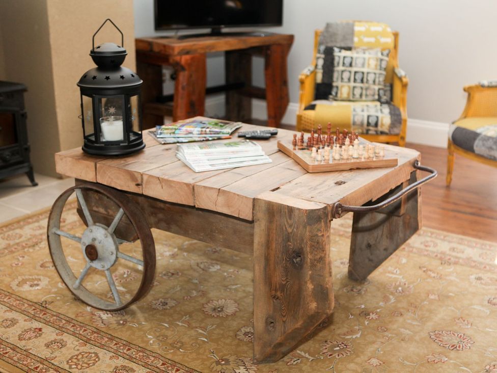 A table with a lantern and chess board in a living room at The Granary in Durham