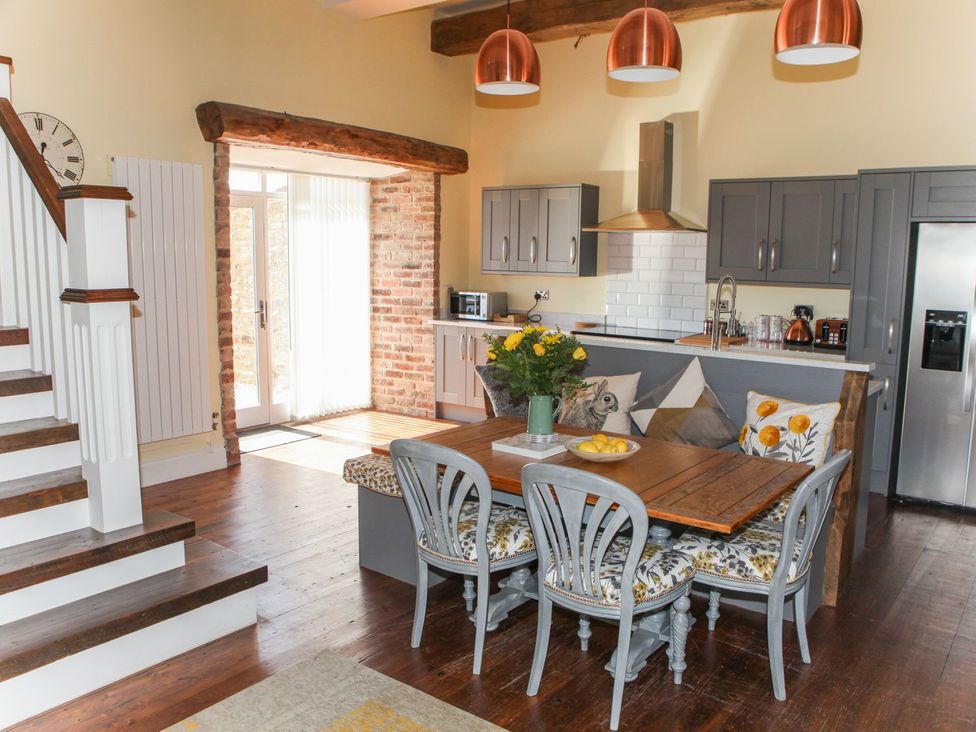 A kitchen with a dining table and chairs at The Granary in Durham