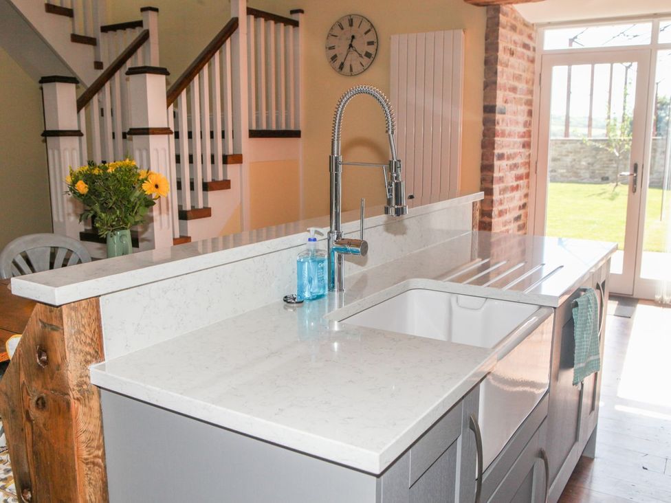 A kitchen with a sink and kitchen faucet at The Granary in Durham