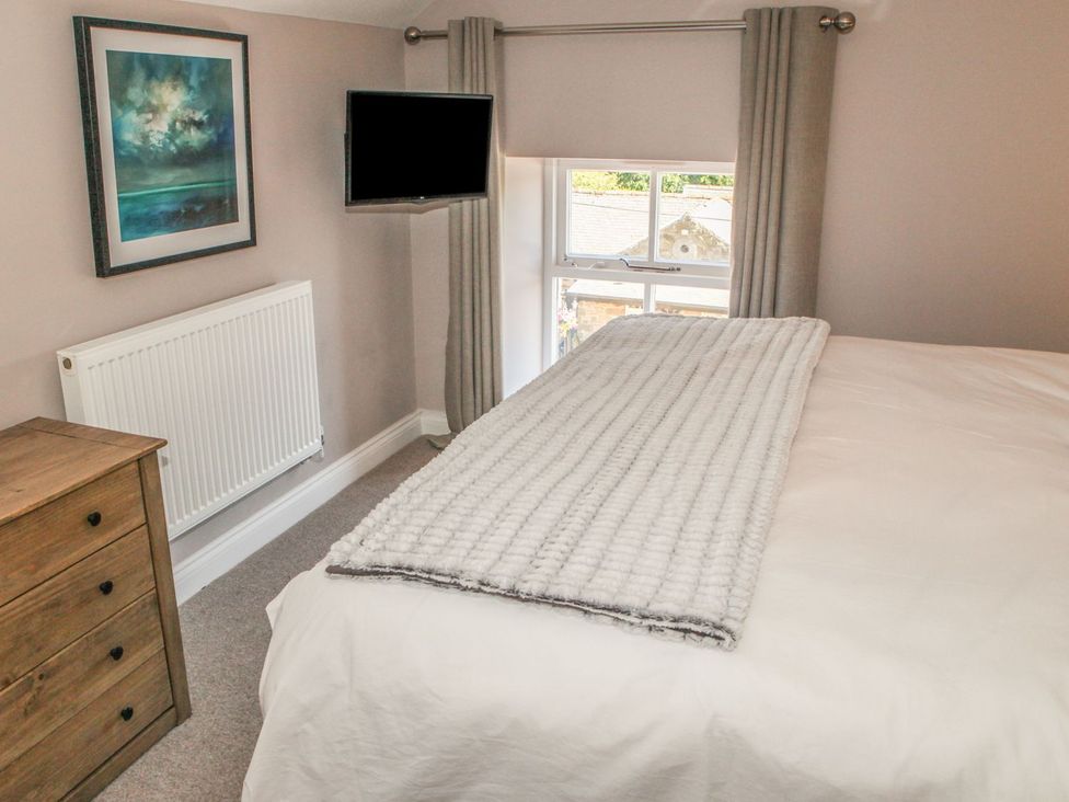 A bedroom with a bed and a television at The Granary in Durham