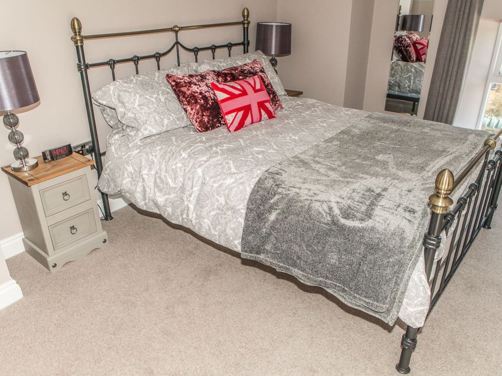 A bedroom with a bed and bedside table at The Granary in Durham