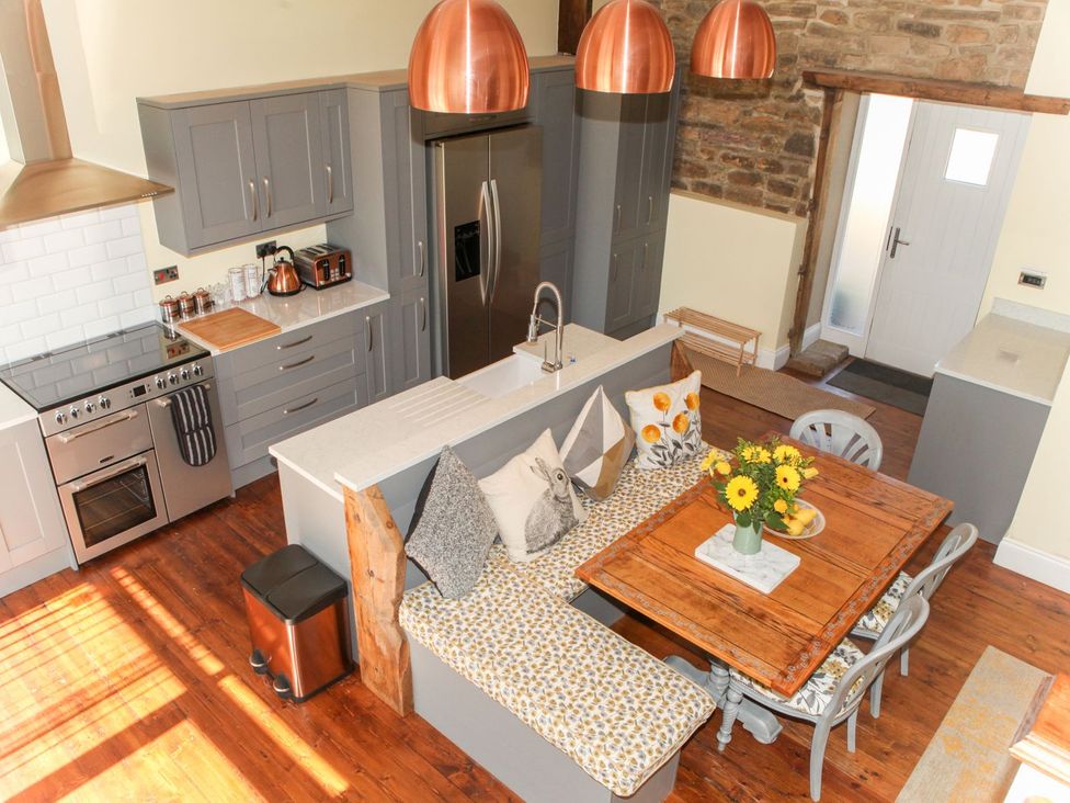 A kitchen with a dining area and modern appliances at The Granary in Durham