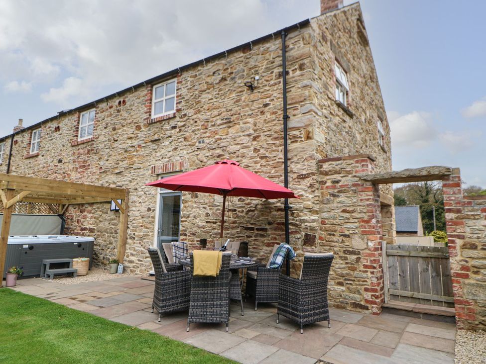 An outdoor area with seating and a hot tub at The Granary in Durham