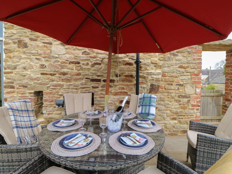 An outdoor dining area with a table and chairs at The Granary in Durham