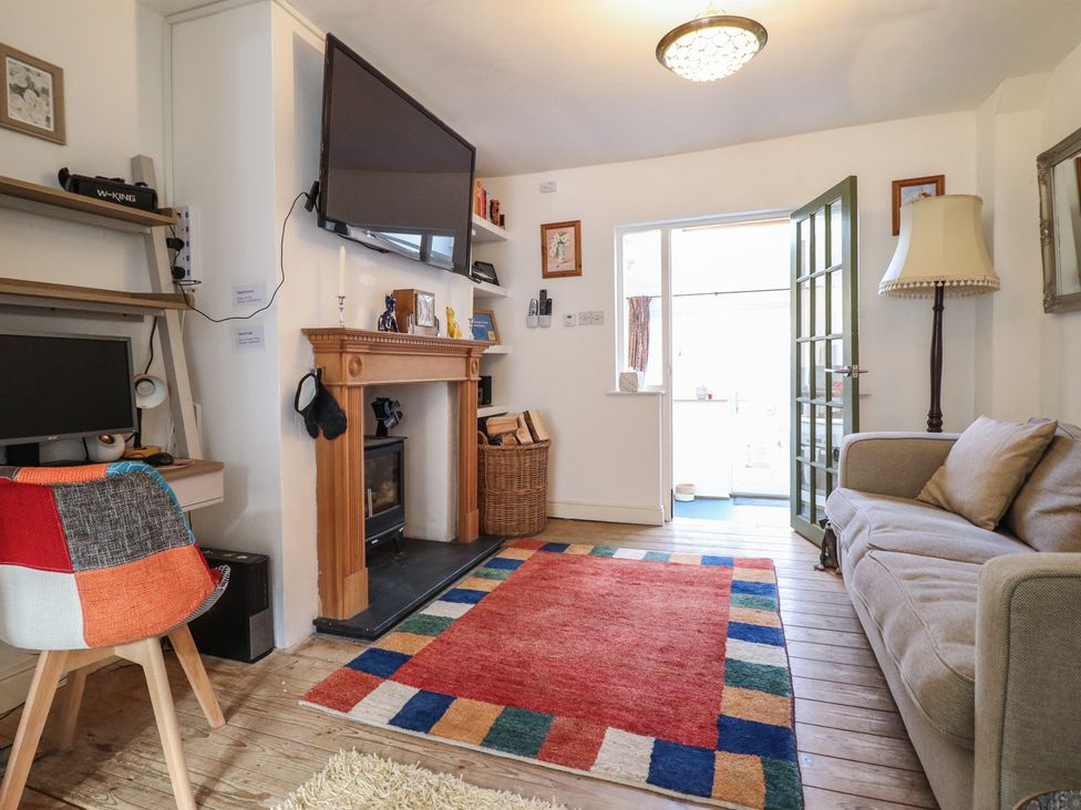 A living room with a television and fireplace at 32 Crescent Street Newtown