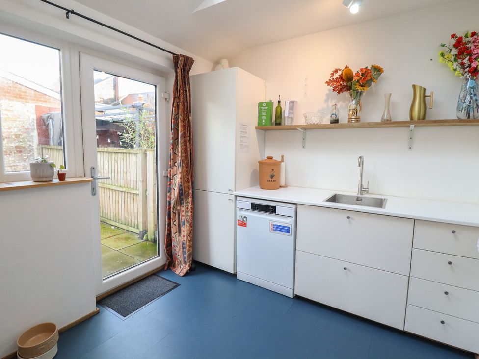 A kitchen with cabinets, sink, and dishwasher at 32 Crescent Street Newtown