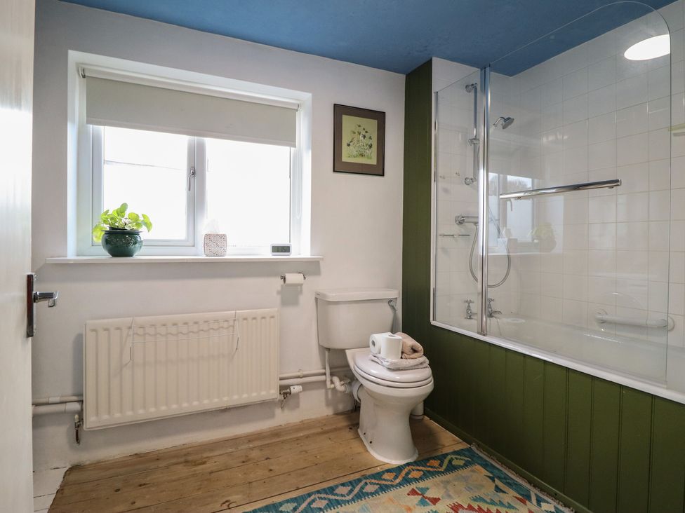 A bathroom with a shower and tub at 32 Crescent Street in Newtown
