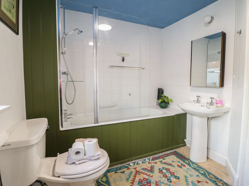 A bathroom with a bathtub and sink at 32 Crescent Street in Newtown