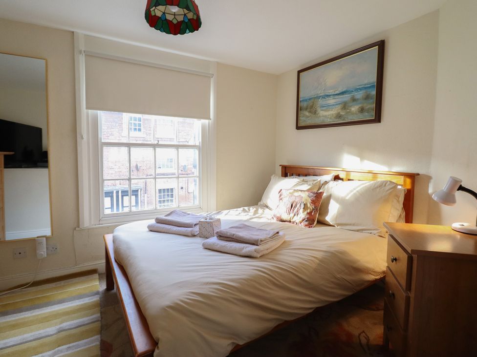 A bedroom with a bed and a nightstand at 32 Crescent Street Newtown