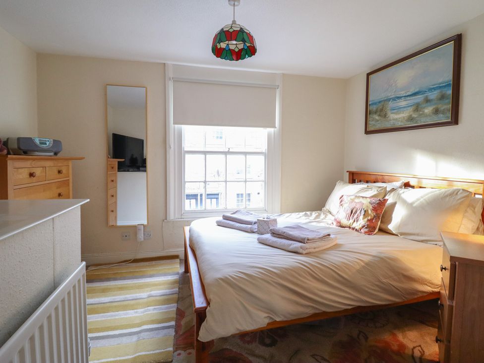 A bedroom with a bed and dresser at 32 Crescent Street in Newtown