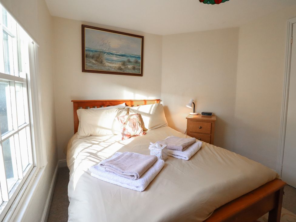 A bedroom with a bed and nightstand at 32 Crescent Street Newtown