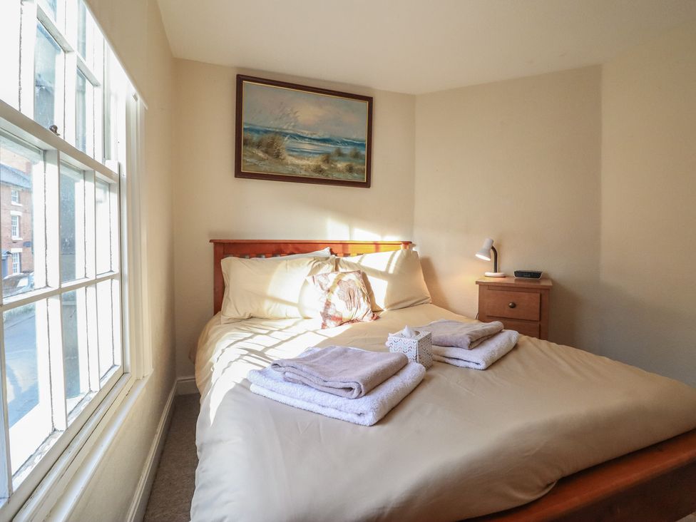 A bedroom with a bed and bedside table at 32 Crescent Street in Newtown