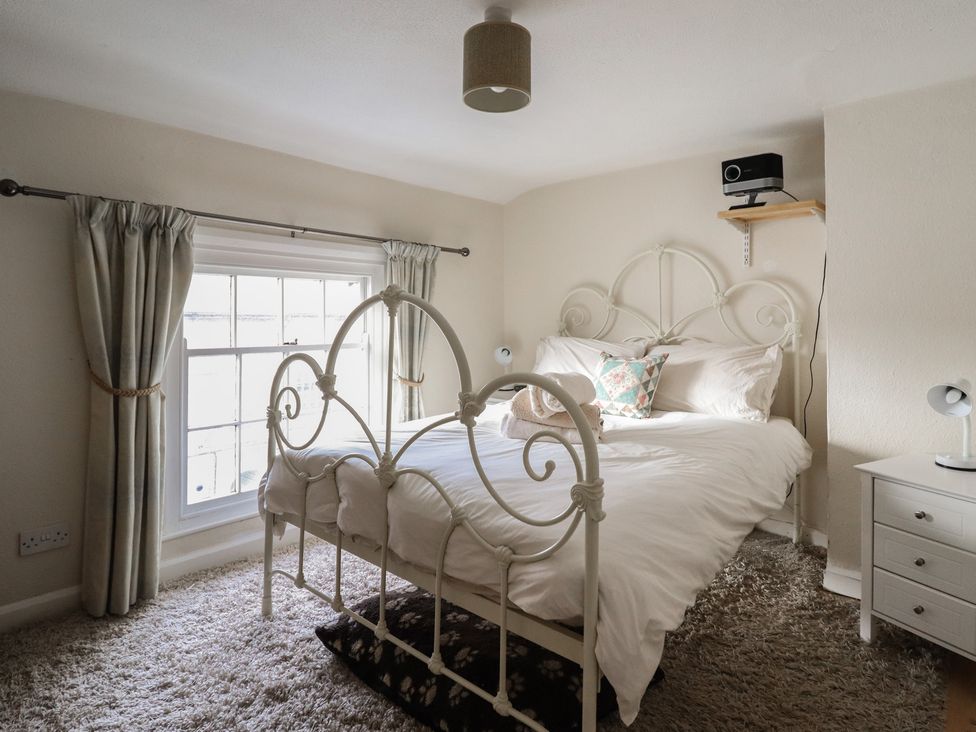 A bedroom with a bed and bedside table at 32 Crescent Street in Newtown